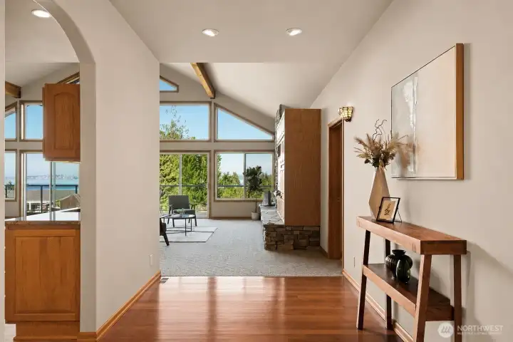 Beautiful hardwoods and vaulted ceilings host the wall of windows with views from every angle. Beautiful hardwoods and vaulted ceilings host the wall of windows with views from every angle.