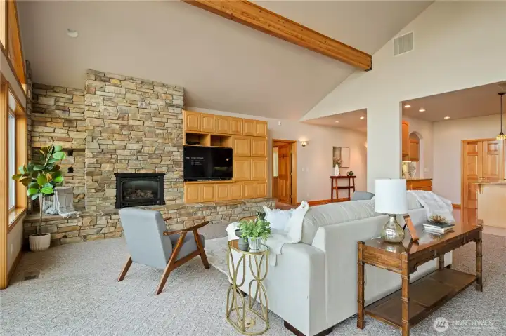 Gorgeous stone fireplace and built-in storage sits just off the open floorplan kitchen. Gorgeous stone fireplace and built-in storage sits just off the open floorplan kitchen.