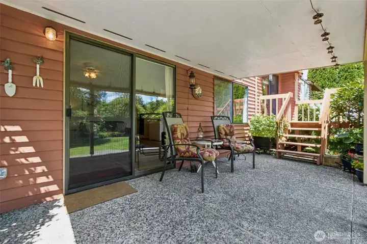 Surrounded by mature landscaping and colorful plantings, this inviting space is perfect for morning coffee, quiet afternoons, or enjoying warm summer evenings in comfort and shade.