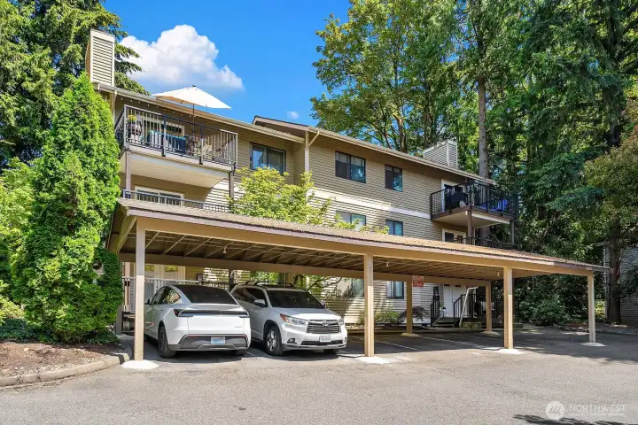 Convenient covered assigned parking. This unit's parking space is third from left, offering convenient access to the unit on the left side of the building shown.