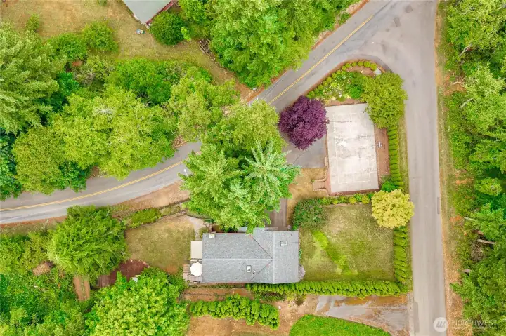A view from above. There is a small shed across the easement road on the right of the home.