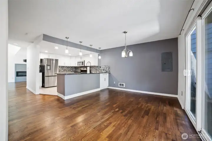 Upon entry greeted with hardwood flooring into the formal dining area and kitchen. There is a second fenced in patio to the right of the dining area.
