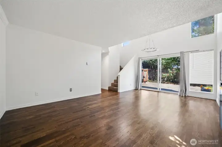 View of dining with small fenced patio area.