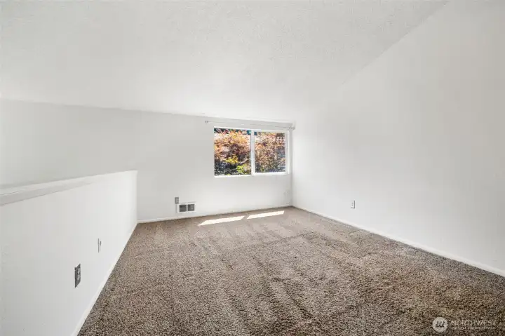 Primary bedroom flooded with natural light and features a walk in closet and 3/4 en suite bathroom.