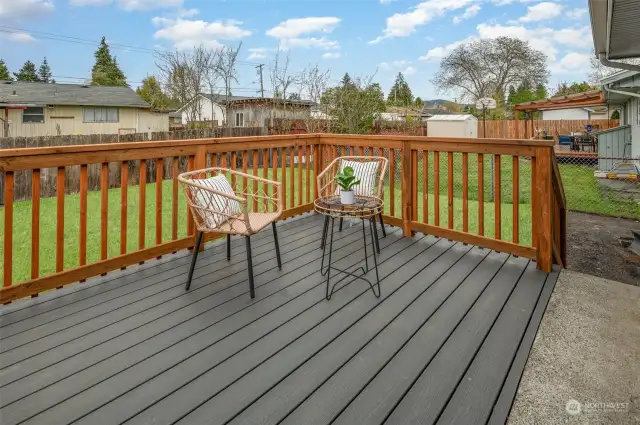 The deck provides a perfect spot for entertaining guests or enjoying a refreshment.