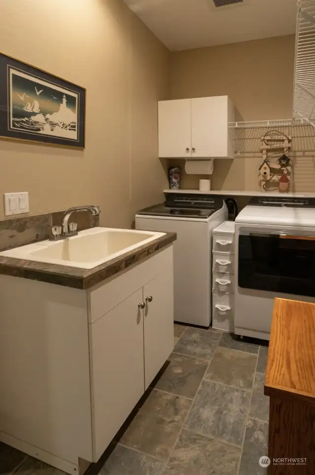 Extra large laundry room with sink and 2 yr old washer/dryer