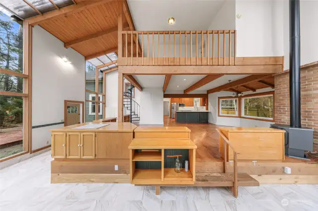 Vaulted ceilings with skylights brighten the great room, showcasing a connection to nature.