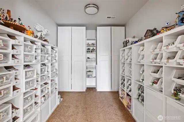 Used for office storage, this space can be easily converted back into a walk-in closet for the second primary suite.