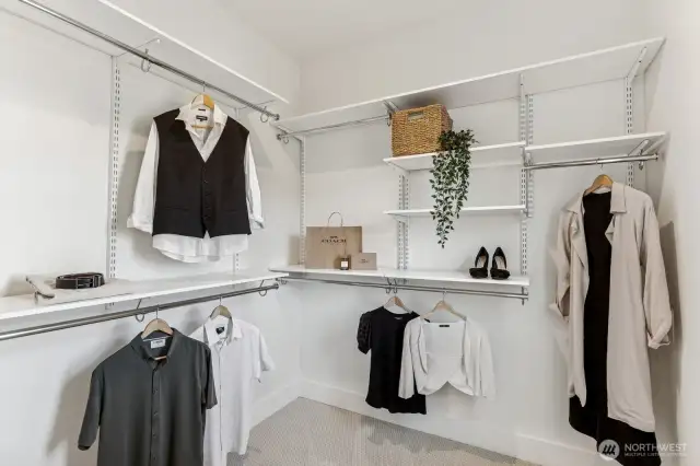 Spacious and functional walk-in closet with adjustable shelving. Plenty of great space for your wardrobe.