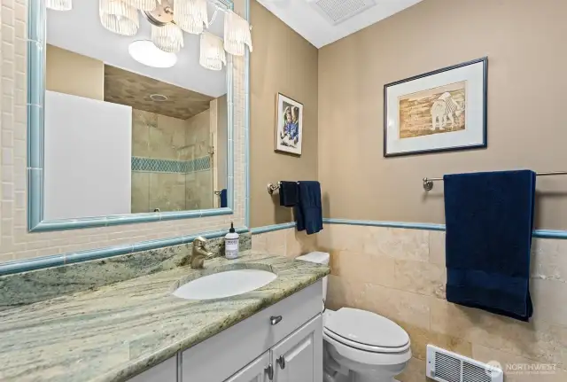 Remodeled 3/4 Bath off the Entry level with Travertine Tile finishes and heated floors.