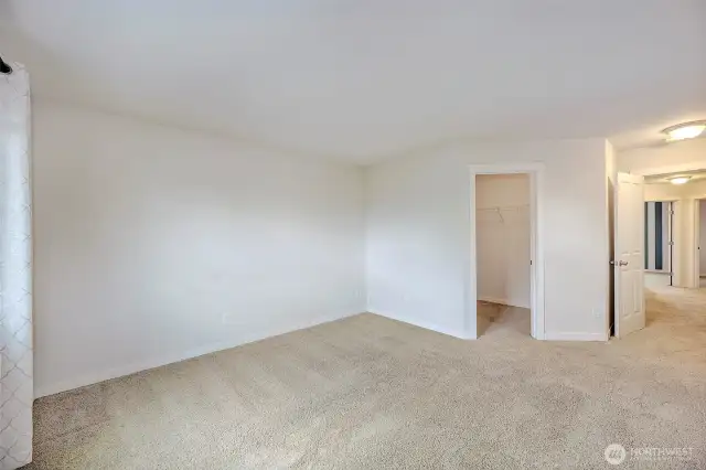 Upper level primary bedroom with a walk in closet.