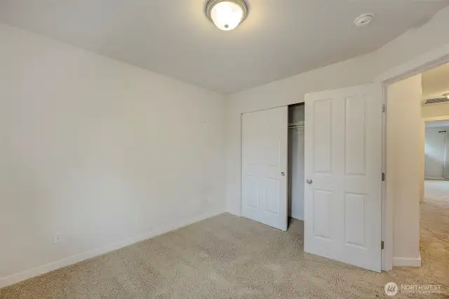 Upper second bedroom with large slider closet and six panel doors throughout.