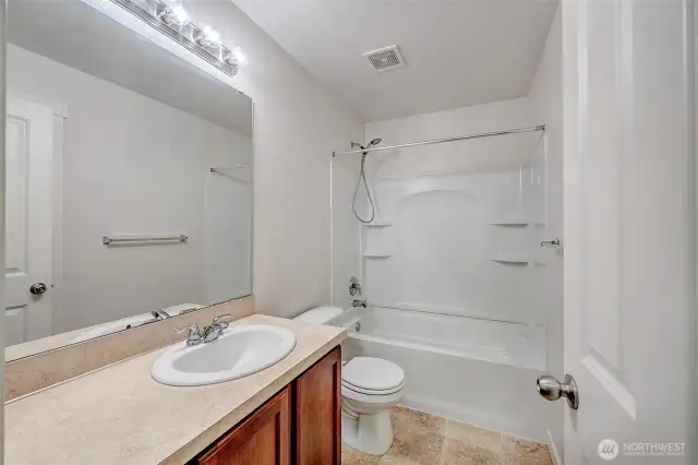 Full upper bathroom with one piece tub surround and linen closet