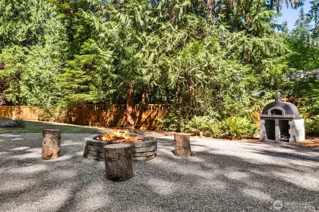 Nestled just beyond the deck is a custom fire pit area, where laughter and storytelling under the stars become part of your everyday life. But the real showstopper? Your very own gourmet pizza oven, ideal for homemade wood-fired creations and unforgettable evenings with friends.