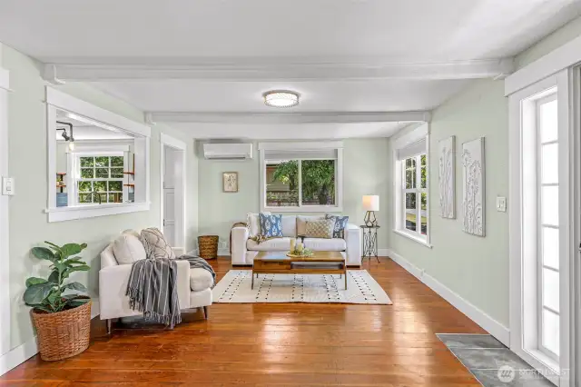 Openings and passthrough to the kitchen create an open and connected living space