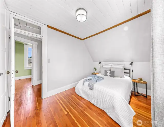 Large upstairs bedroom with a full wall of built in closets and large West facing windows