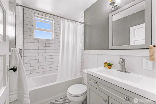 Upstairs bathroom with custom tile surround and floor.