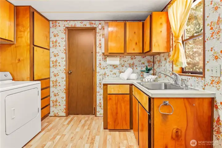Laundry room with storage and wash sink.