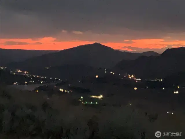 Sparkling Horizon-Beyond the ridgeline, faint lights twinkle in the valley below—enchanting evenings await