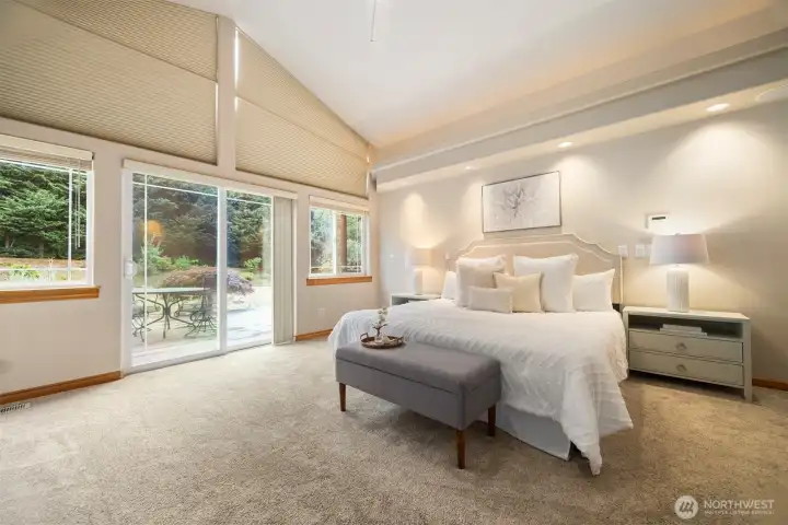 Primary Bedroom looking over the deck with Hot Tub.