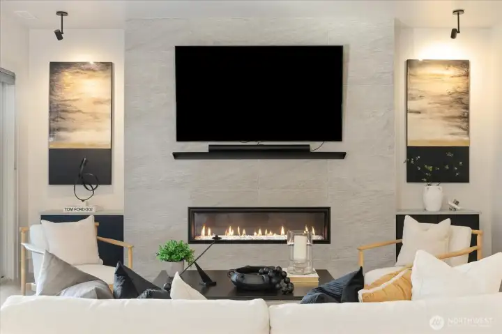 72” Crave linear fireplace with tile surround, custom metal mantle and Built-in cabinets in this well appointed living room