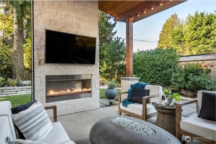 Vaulted outdoor patio with fireplace and floor to ceiling stone surround