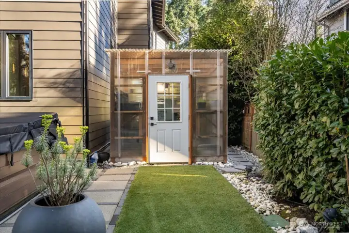Backyard Jacuzzi to your left, Greenhouse straight ahead. Both stay with the home.
