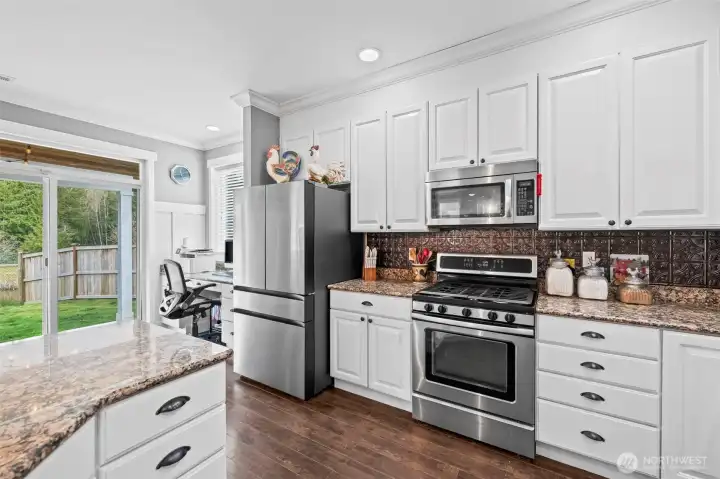 view from kitchen looking out towards the covered patio and back yard