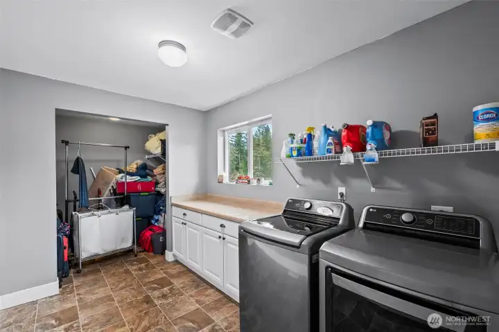 Oversized laundry room with extra storage and space for crafts/hobbies