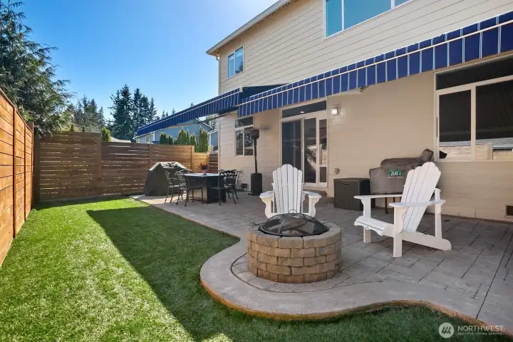 Backyard showing 2 separate awnings extended (remote control or manual) to different lengths to allow varied coverage for year round enjoyment.