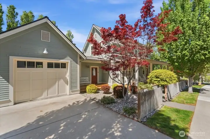 Exterior view of home with attached 2-car garage and classic covered front porch.