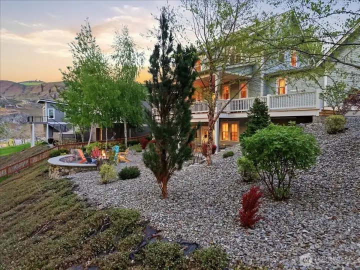 Exterior side view of large, landscaped west-facing lot.