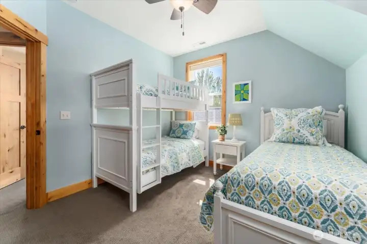 View of upper level bunk room with additional trundle bed.