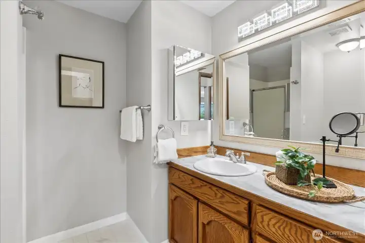 Primary bedroom features a generous 3/4 bath with oversized vanity.
