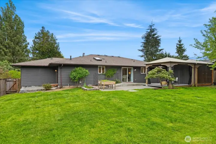 What a glorious and level backyard.  Plenty of room to enjoy summer months gardening, sprinklers, volleyball, living life!