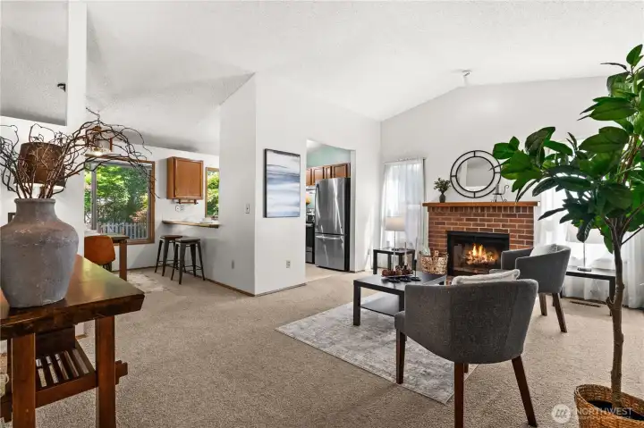 The wood burning fireplace creates an inviting atmosphere with abundant natural light. The wood burning fireplace creates an inviting atmosphere with abundant natural light.
