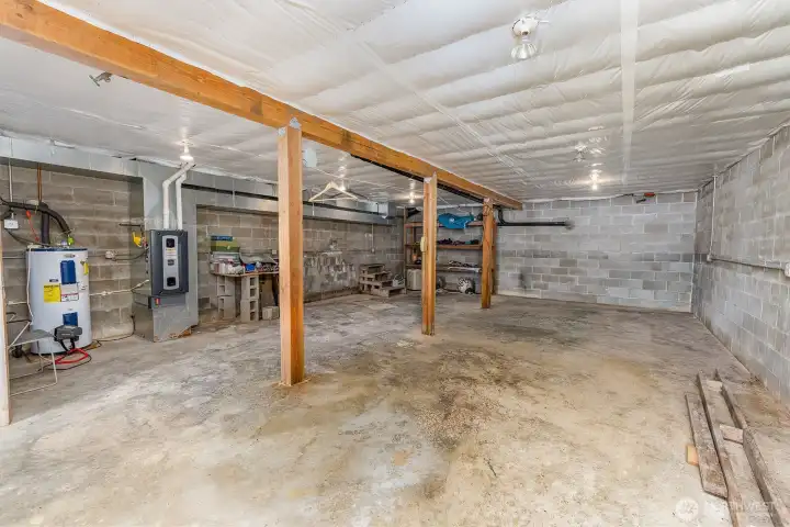 Unfinished basement with storage.