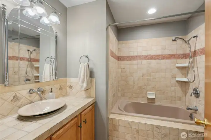 Full bathroom featuring tile finishes. Full bathroom featuring tile finishes.