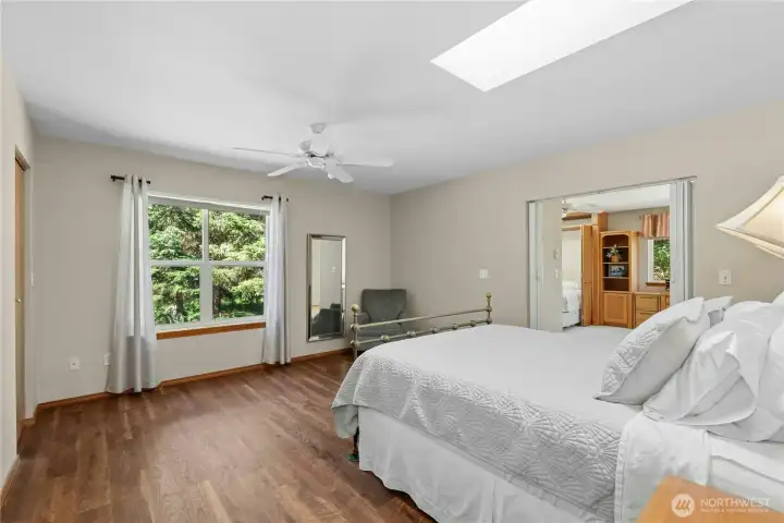 A peaceful primary retreat featuring an en suite bath, attached office space, and tranquil views of the surrounding greenery. A peaceful primary retreat featuring an en suite bath, attached office space, and tranquil views of the surrounding greenery.