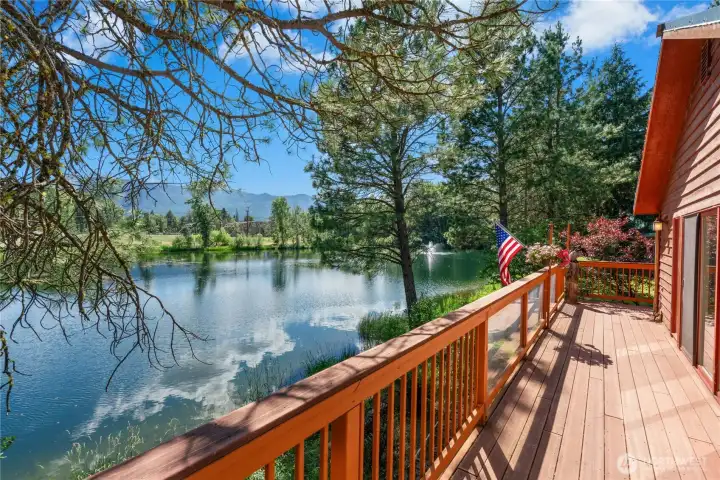Take in views of the pond and surrounding mountains from the expansive deck—an ideal setting for morning coffee or evening gatherings. Take in views of the pond and surrounding mountains from the expansive deck—an ideal setting for morning coffee or evening gatherings.