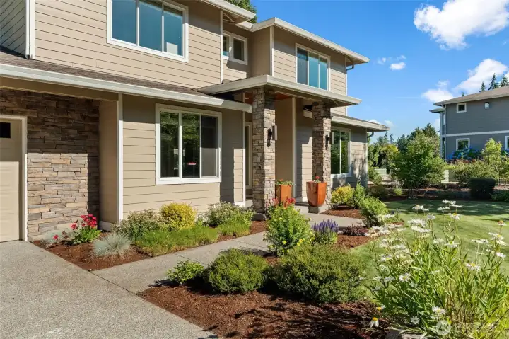 Beautifully maintained landscaping enhances the welcoming covered front porch. Beautifully maintained landscaping enhances the welcoming covered front porch.
