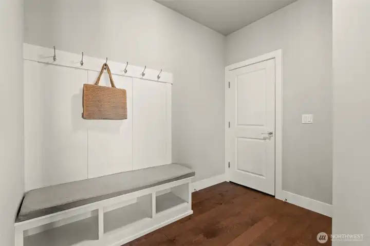 Functional mudroom features a built-in bench, open storage cubbies, and coat hooks, creating a convenient everyday organization space. Functional mudroom features a built-in bench, open storage cubbies, and coat hooks, creating a convenient everyday organization space.