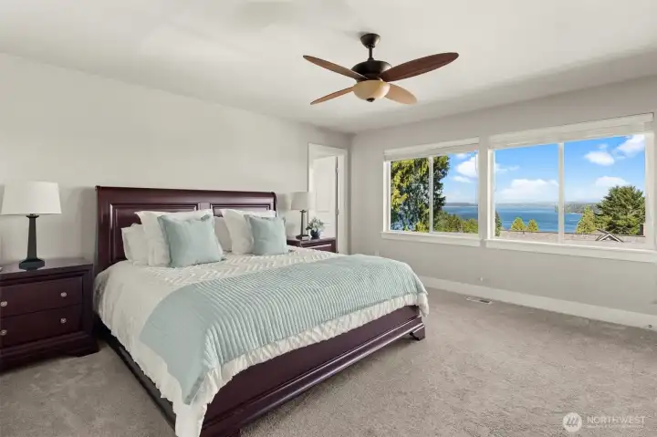 Wake up to panoramic water views from the comfort of the spacious primary bedroom. Wake up to panoramic water views from the comfort of the spacious primary bedroom.