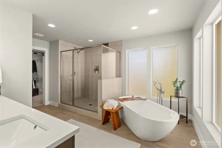 Spacious primary bathroom features a freestanding soaking tub, tiled walk-in shower, and walk-in closet access. Spacious primary bathroom features a freestanding soaking tub, tiled walk-in shower, and walk-in closet access.