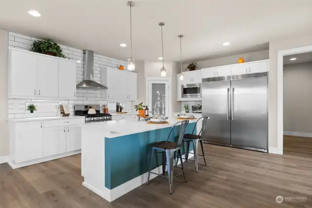 In this luxurious chef's kitchen, the stainless steel refrigerator is not just a functional appliance—it's a symbol of culinary sophistication and artistic inspiration, inviting you to indulge in the pleasures of gourmet cooking and fine dining in the comfort of your own home.
