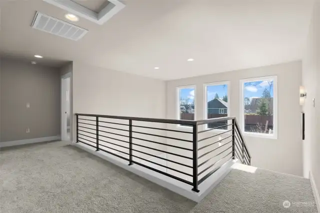 One of the key benefits of the metal railing is its ability to open up the space, creating a sense of airiness and expansiveness within the home. The sleek lines and minimalist design of the railing allow for unobstructed views from both the staircase and the balcony.
