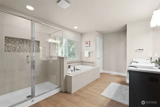 You will be in awe of the elegant finishes at every turn.  Stylish mosaic inlaid shower tiling add the perfect detail to the already beautiful bathroom.  A private water closet offers additional privacy.