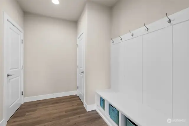 The spacious mudroom just beyond the garage door serves as a practical and functional entry point to your home. With its generous size and thoughtful design, the mud room provides the perfect space for storing and organizing daily essentials, ensuring that everything has its place and is easily accessible when needed.