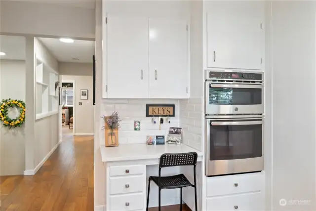 Continued Kitchen w/ work desk, looking down the hallway to bedrooms