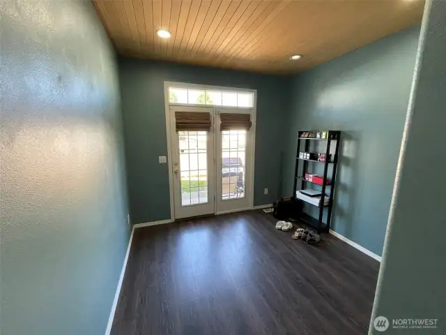3rd bedroom with French door leading to back yard.